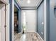 Inviting entryway with wood-look flooring, neutral wall colors, and a decorative plant adding a touch of nature at 140 Trinity Ridge Cir, Davenport, FL 33897