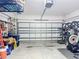Spacious garage with white door providing ample room for parking and storage of equipment at 140 Trinity Ridge Cir, Davenport, FL 33897