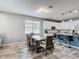 A kitchen and dining area features an island with seating and stainless steel appliances at 140 Trinity Ridge Cir, Davenport, FL 33897