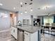 A modern kitchen island with granite countertop is the focal point in this open-concept layout at 140 Trinity Ridge Cir, Davenport, FL 33897