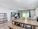 Open concept living space with wood-look tile flooring, neutral walls, and an access to the patio at 140 Trinity Ridge Cir, Davenport, FL 33897