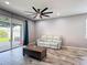 Living room with tile floors and sliding glass doors leading to the outside patio at 140 Trinity Ridge Cir, Davenport, FL 33897