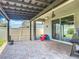 Inviting covered patio with brick flooring, perfect for outdoor entertaining with a glimpse of the lush backyard at 140 Trinity Ridge Cir, Davenport, FL 33897