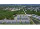 Community aerial showcases townhomes, lush landscaping, pond, and surrounding residences at 1425 Serendipity Ln, Clermont, FL 34714