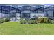 Lush backyard showcasing screened-in patios, and well-maintained landscaping at 1425 Serendipity Ln, Clermont, FL 34714