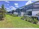 Beautiful backyard featuring multiple screened-in patios, lush green lawn, and mature trees at 1425 Serendipity Ln, Clermont, FL 34714