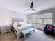 Cozy bedroom with soft natural light, stylish furniture and a contemporary ceiling fan at 1425 Serendipity Ln, Clermont, FL 34714