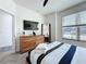 Bedroom features a wooden dresser, closet, ceiling fan and a sunlit window at 1425 Serendipity Ln, Clermont, FL 34714