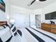 Modern bedroom features a ceiling fan, and dresser with an elephant figurine at 1425 Serendipity Ln, Clermont, FL 34714