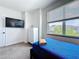 Well-lit bedroom with large window, comfortable bed, and minimalist decor at 1425 Serendipity Ln, Clermont, FL 34714