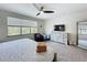 Bedroom with large windows and a ceiling fan offering comfortable climate control and natural light at 1425 Serendipity Ln, Clermont, FL 34714