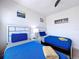 Charming bedroom with twin beds, modern decor, and ample natural light at 1425 Serendipity Ln, Clermont, FL 34714