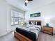 Bright bedroom featuring a modern wooden bed frame and bedside tables at 1425 Serendipity Ln, Clermont, FL 34714