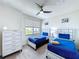 Bright bedroom with twin beds, chest of drawers, and a large window at 1425 Serendipity Ln, Clermont, FL 34714