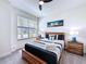 Bright bedroom featuring a modern wooden bed frame and bedside tables at 1425 Serendipity Ln, Clermont, FL 34714