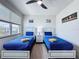 Bright bedroom with twin beds, a window view, and chest of drawers at 1425 Serendipity Ln, Clermont, FL 34714