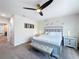 Serene bedroom with gray carpeting, a ceiling fan and elegant furnishings creating a peaceful sanctuary at 1425 Serendipity Ln, Clermont, FL 34714