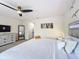 Spacious bedroom featuring modern furnishings, ceiling fan, and ample closet space at 1425 Serendipity Ln, Clermont, FL 34714