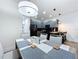 Open concept dining room adjacent to a contemporary kitchen and a modern lighting fixture at 1425 Serendipity Ln, Clermont, FL 34714