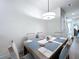 Inviting dining area with stylish table setting and modern light fixture at 1425 Serendipity Ln, Clermont, FL 34714