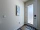 Bright entryway features a modern door with frosted glass and neutral-toned walls with a bird print at 1425 Serendipity Ln, Clermont, FL 34714