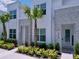 Front exterior showing modern townhome design with elegant stone and lush tropical landscaping at 1425 Serendipity Ln, Clermont, FL 34714
