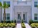 Charming townhome exterior with decorative stone accents, lush landscaping, and welcome entry at 1425 Serendipity Ln, Clermont, FL 34714