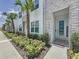 Modern townhome showcasing manicured landscaping, stone accents, and a welcoming front entrance at 1425 Serendipity Ln, Clermont, FL 34714