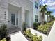 Attractive townhouse entrance with stone detailing, lush landscaping, and a welcoming doorway at 1425 Serendipity Ln, Clermont, FL 34714