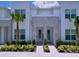 Inviting townhome entrance with manicured landscaping, stone accents, and a bright, modern facade at 1425 Serendipity Ln, Clermont, FL 34714