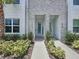 Beautiful townhouse exterior featuring modern design, vibrant landscaping, and welcoming entrances at 1425 Serendipity Ln, Clermont, FL 34714