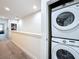 Bright hallway with gray carpeting leads to an in-unit washer and dryer, adding convenience at 1425 Serendipity Ln, Clermont, FL 34714
