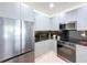 The modern kitchen features stainless steel appliances, sleek cabinets, and ample counter space for cooking at 1425 Serendipity Ln, Clermont, FL 34714