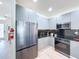 Stainless steel refrigerator and appliances complement sleek cabinets in this modern, stylish kitchen design at 1425 Serendipity Ln, Clermont, FL 34714