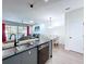 Open-concept kitchen with modern appliances, great for entertaining, flows into the living and dining areas at 1425 Serendipity Ln, Clermont, FL 34714