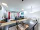 Bright, open-concept design with sleek countertops and stainless steel appliances provides convenience and style at 1425 Serendipity Ln, Clermont, FL 34714
