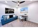 Cozy living room features comfortable blue couch, modern desk, and contemporary decor at 1425 Serendipity Ln, Clermont, FL 34714