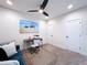 The spacious living room boasts neutral tones, stylish desk, and access to multiple doors at 1425 Serendipity Ln, Clermont, FL 34714