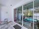 Covered patio featuring sliding glass doors that lead to a screened-in pool area at 1425 Serendipity Ln, Clermont, FL 34714