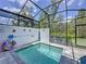 Beautiful screened-in pool surrounded by lush greenery and a tranquil atmosphere at 1425 Serendipity Ln, Clermont, FL 34714