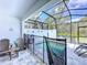 Screened-in pool area with a safety fence, lounge chairs, and lush surroundings for ultimate privacy at 1425 Serendipity Ln, Clermont, FL 34714