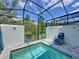 Serene screened-in pool with a lounge chair for relaxation at 1425 Serendipity Ln, Clermont, FL 34714