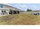 Large grassy backyard with patio, pergola, string lights and privacy fence at 1490 Olive Ct, St Cloud, FL 34771
