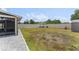 Large backyard featuring a patio area, white pergola, and ample space for outdoor activities at 1490 Olive Ct, St Cloud, FL 34771