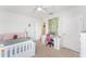 This bedroom features a ceiling fan, carpet flooring, white walls, bed and desk with a vanity at 1490 Olive Ct, St Cloud, FL 34771