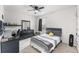 This bedroom features a ceiling fan, a window, a bed, a dresser, and a desk at 1490 Olive Ct, St Cloud, FL 34771