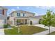 Well-maintained home featuring a manicured lawn, complemented by a welcoming front porch and two-car garage at 1490 Olive Ct, St Cloud, FL 34771