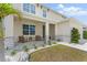 Inviting front porch with a cozy seating area, stone accents, and lush landscaping at 1490 Olive Ct, St Cloud, FL 34771