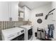 Chic laundry room featuring stylish wallpaper, modern appliances, and ample storage at 1490 Olive Ct, St Cloud, FL 34771
