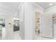 Bright and airy living room featuring modern white tile floors and an adjacent half bathroom at 1490 Olive Ct, St Cloud, FL 34771